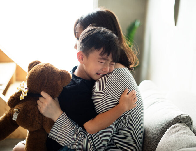 A mother comforting her crying child